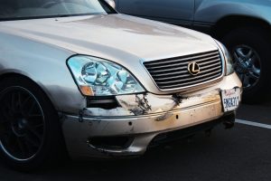 a car that has been badly damaged in a parking lot