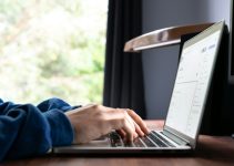 person using macbook pro on table